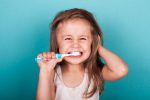 Cute little girl brushing her teeth